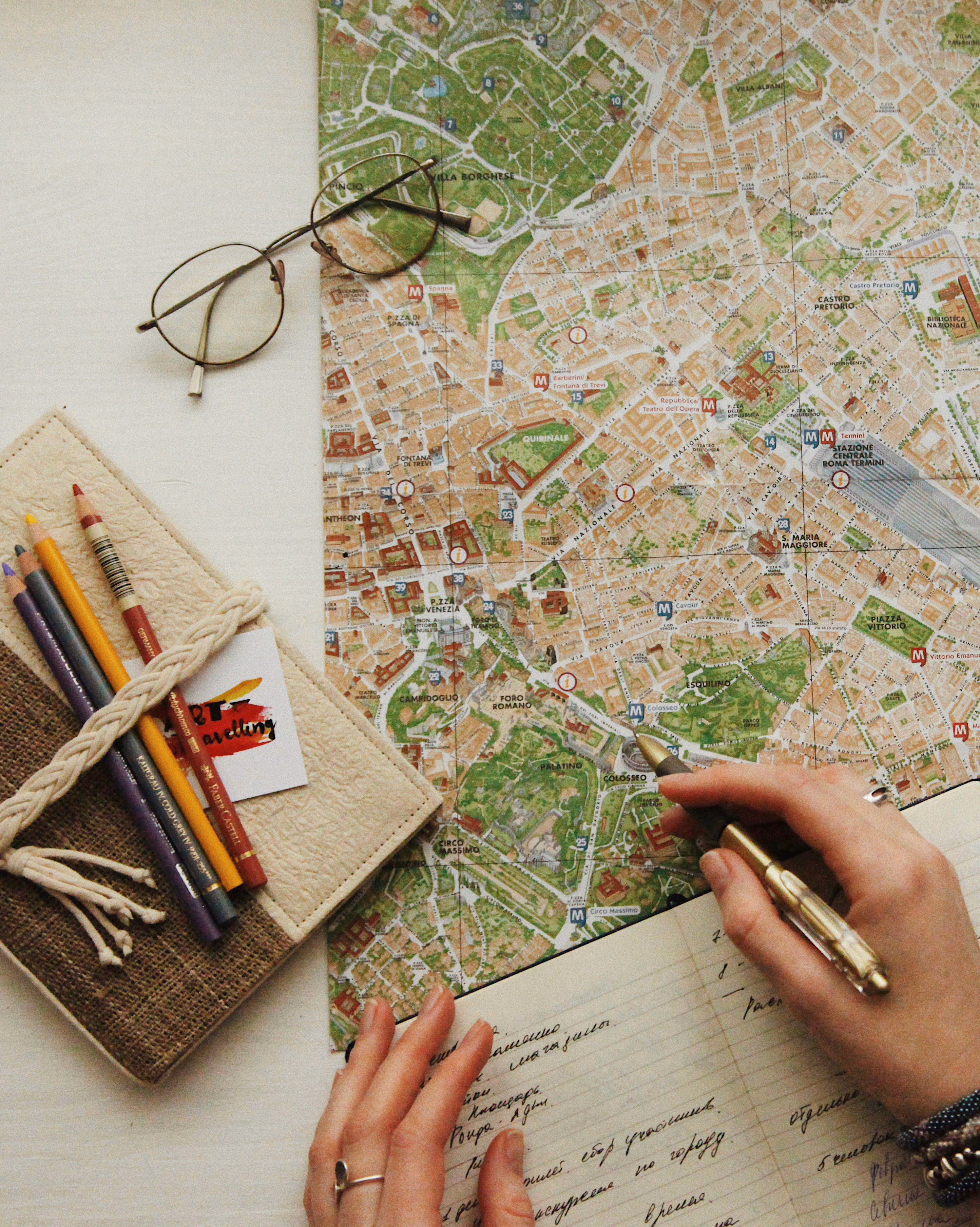 Travel map with pencils and glasses — planning a trip